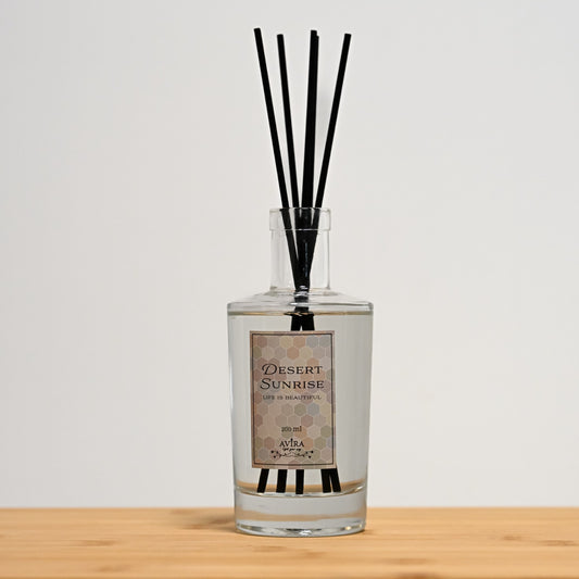 מפיץ ריח 200 מ"ל בניחוח זריחה במדבר עם מקלות שחורים בכלי זכוכית שקוף, אטום בפקק וינילוק – ועליו הכיתוב "LIFE IS BEAUTIFUL".